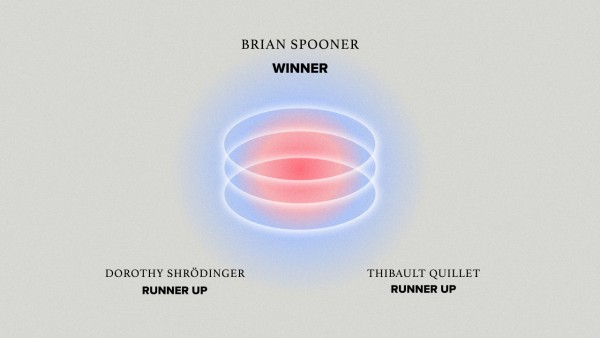 On a blue background a graphic of 3 overlapping opaque circles sits in the centre. In the middle of the circles the background changes to red - like a flame. Above the graphic is black text reads: ‘Brian Spooner, Winner’ . Below the graphic also in black reads: ‘Dorothy Shrödinger, runner up’ (to the left) Thibault Quillet, runner up’ (to the right)