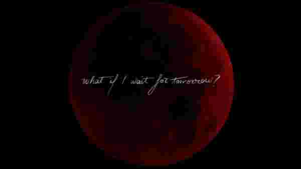 Full moon in a red tint on a black sky, in handwriting written acorss 'What If I wait for tomorrow?'