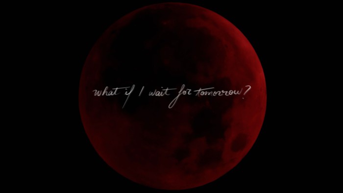 Full moon in a red tint on a black sky, in handwriting written acorss 'What If I wait for tomorrow?'