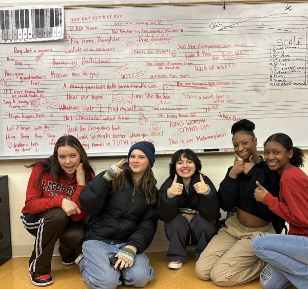 Five young singer crouch infront of a white board with quotes on it , all over, quotes from songs they sang this season. Thei are showing thumbs up and smiling.